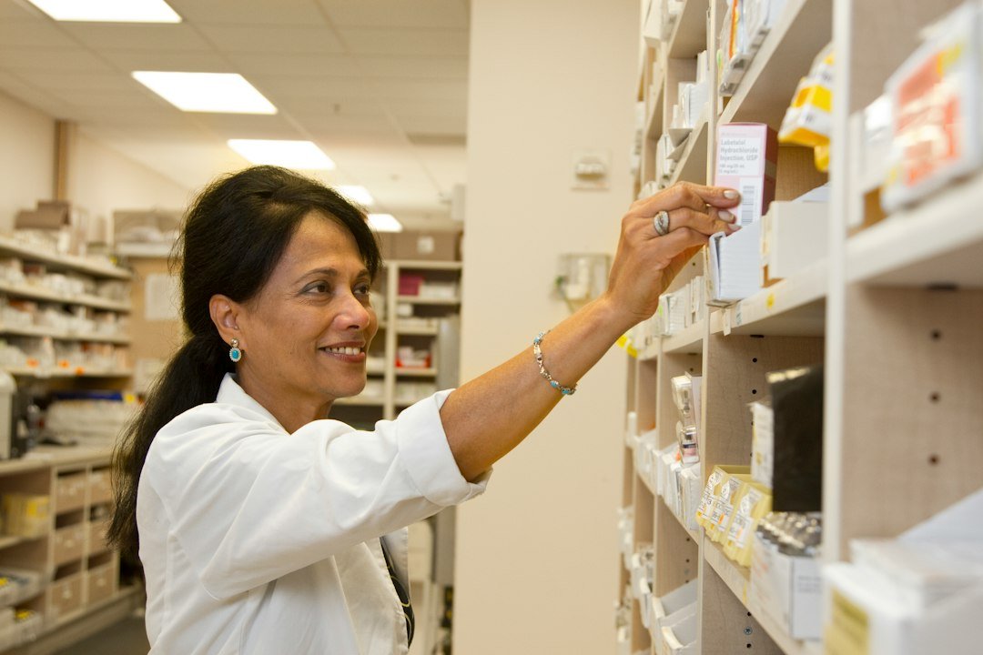 Pharmacist examining prescription medicine in pharmacy for U.S. international mail customs regulation news
